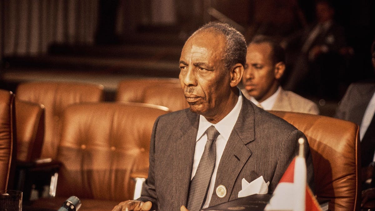 Mohammed Siad Barre stands for a portrait photograph.